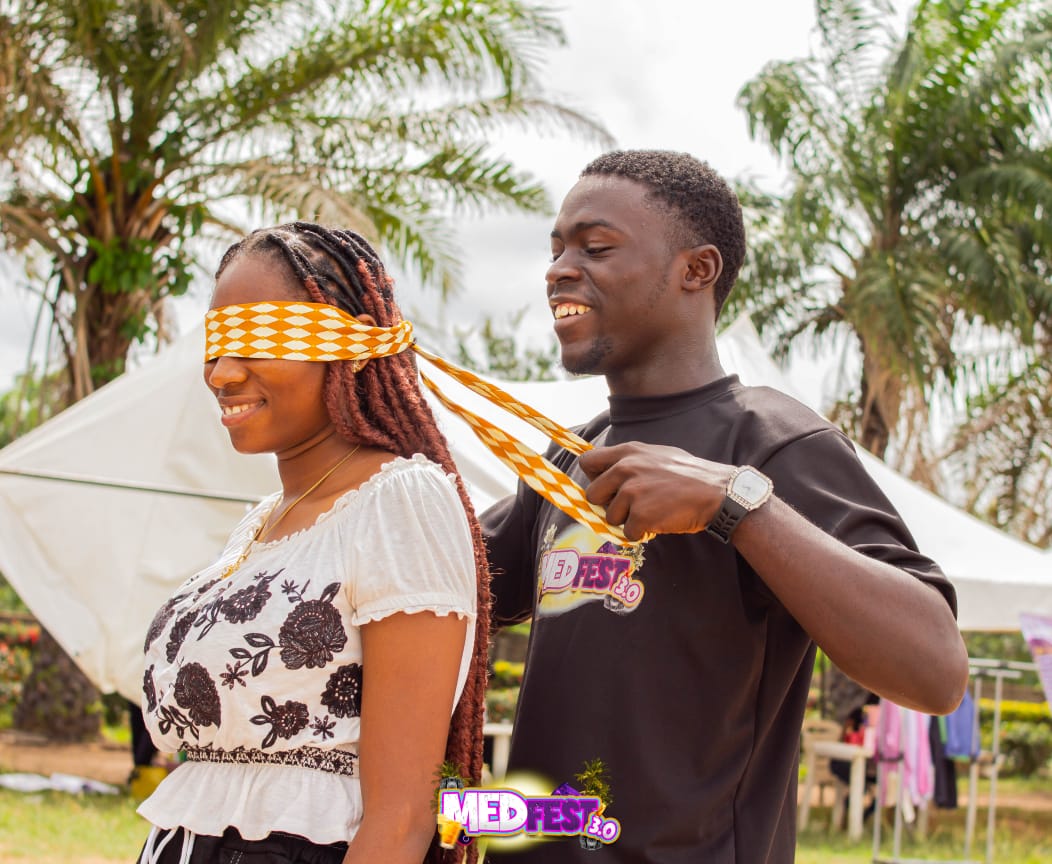 A blindfolded guest laughing during a game